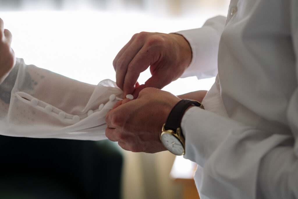 Bride and groom getting ready during winter wedding in Jackson, NH