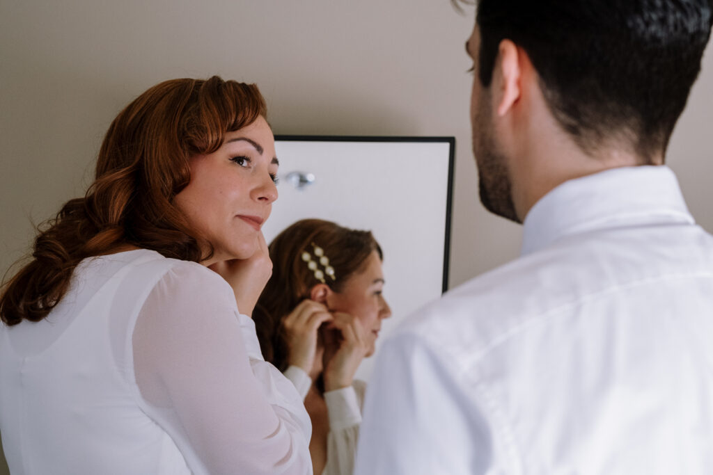 Bride and groom getting ready during winter elopement in the White Mountains