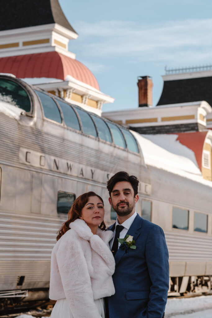 Bride and groom in front of Conway Scenic Railroad station in North Conway, NH