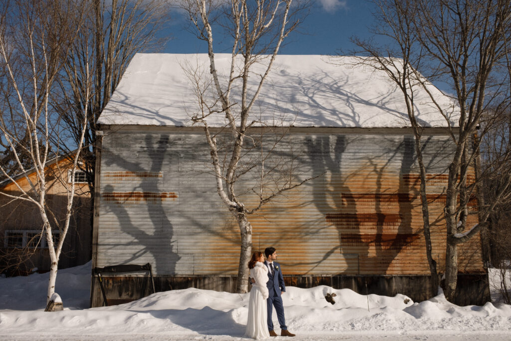 Bride and groom in the snow during winter elopement in the White Mountains