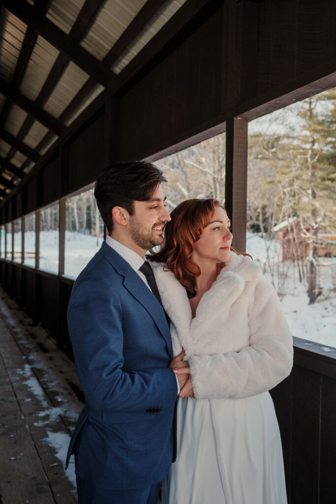 Bride and groom on covered bridge in Jackson New Hampshire