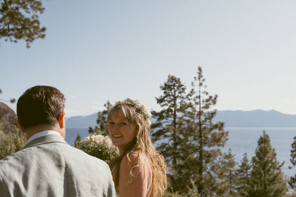 Bride and groom walking along the cliffs overlooking Lake Tahoe