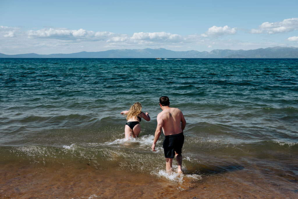 Couple jumping into the water on Lake Tahoe