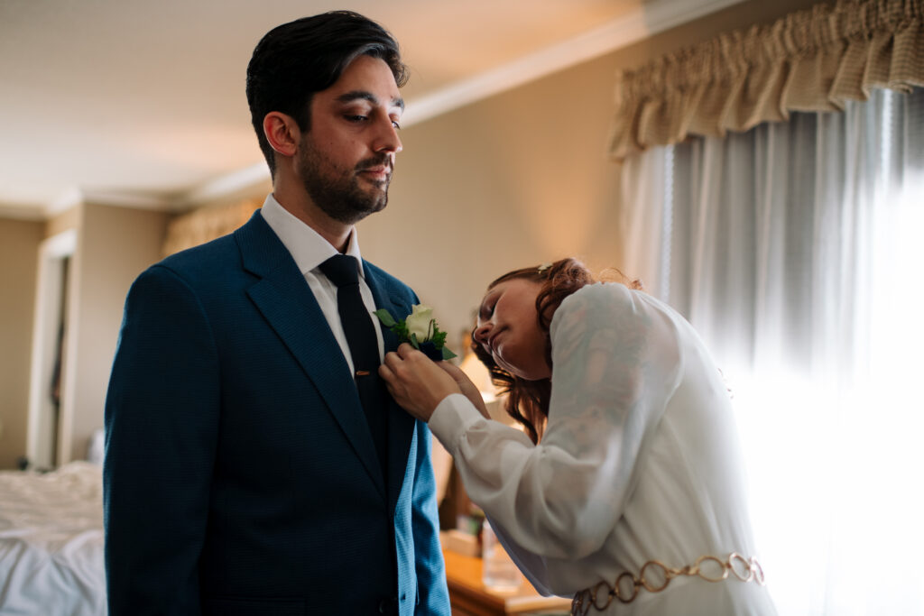 Bride and groom getting ready during winter elopement in the White Mountains