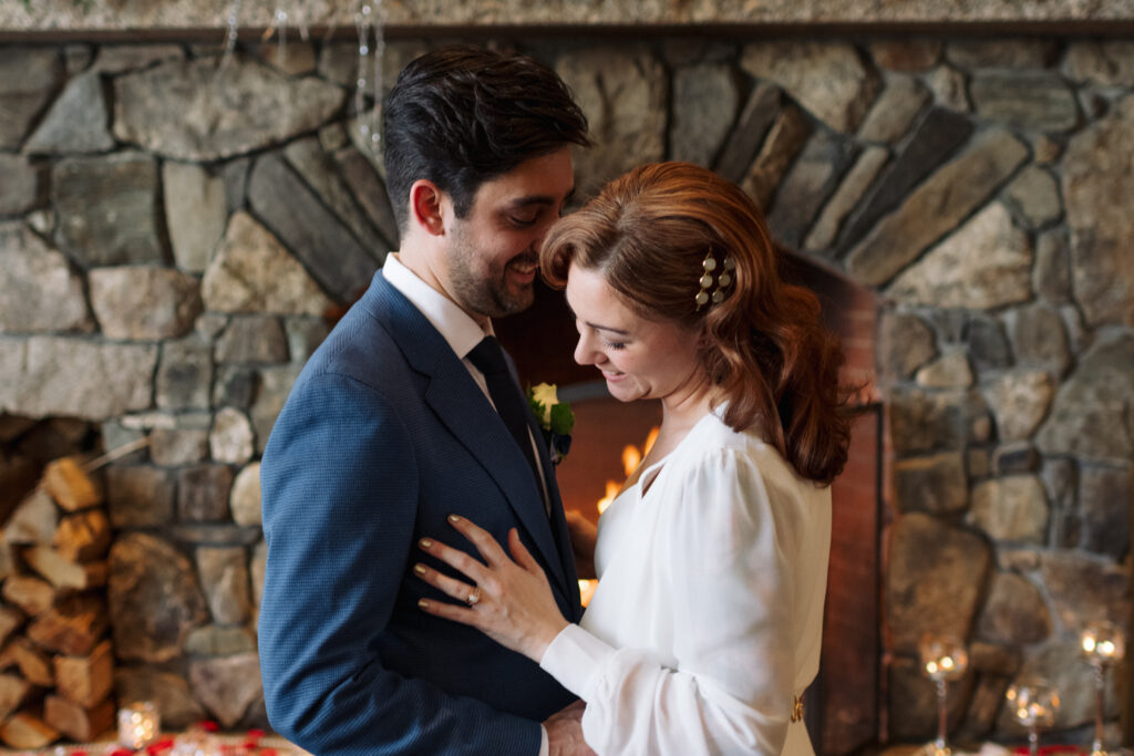 Cozy, fireplace wedding ceremony for winter elopement in the white mountains